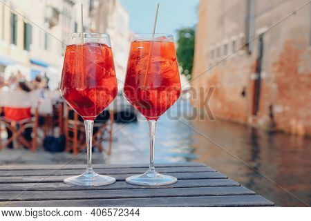 Two Glasses Of Spritz Veneziano Cocktail Served Near The Venetian Canal.  Popular Italian Summer Ape
