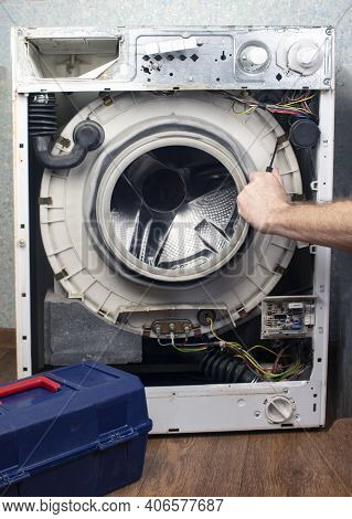 Washing Machine Repair. The Front Wall Has Been Removed From The Washing Machine, The Internal Units