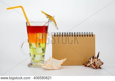 Bright Summer Cocktail In A Glass And Notebook. Travel Concept.