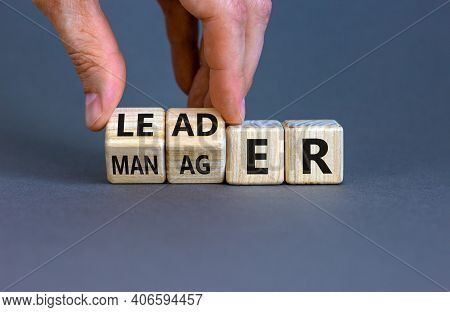 Manager Versus Leader Symbol. Businessman Flips Wooden Cubes And Changes The Word 'manager' To 'lead
