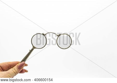 Hand Hold An Old Vintage Lorgnette From The Middle Of The Nineteenth Century On The White Background