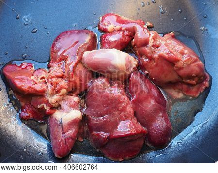 Chicken Liver, Kidney And Heart In A Non-stick Skillet. The Offal Of The Bird Is Placed In A Dark Bo