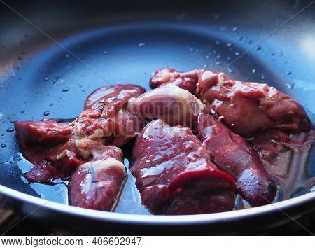 Chicken Liver, Kidney And Heart In A Non-stick Skillet. The Offal Of The Bird Is Placed In A Dark Bo