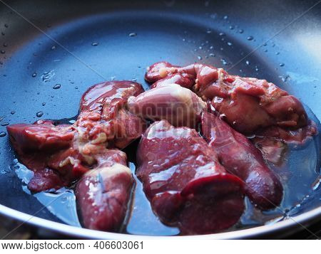Chicken Liver, Kidney And Heart In A Non-stick Skillet. The Offal Of The Bird Is Placed In A Dark Bo