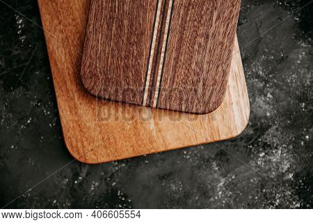 Set Of Wooden Cuttng Boads On Black Background. Wooden Kitchen Block Close Up.