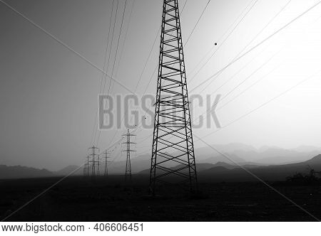 Sand Storm In The Desert Near Eilat Upon Power Line Supports