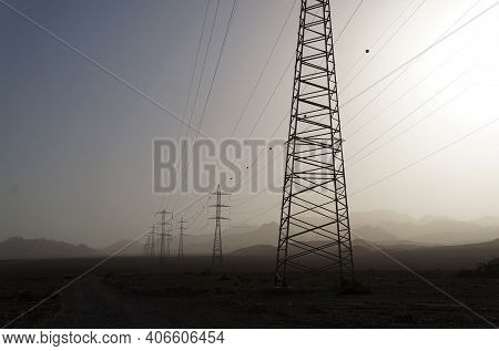 Sand Storm In The Desert Near Eilat Upon Power Line Supports