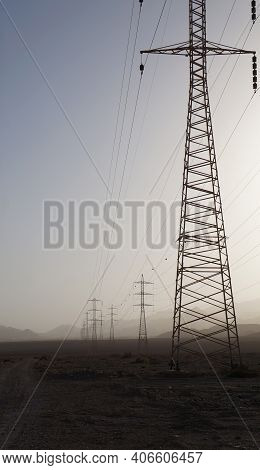 Sand Storm In The Desert Near Eilat Upon Power Line Supports