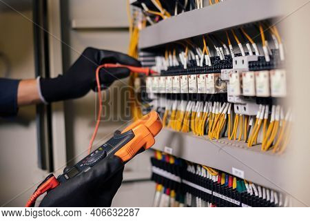 Electrician Engineer Work Tester Measuring Voltage And Current Of Power Electric Line In Electical C