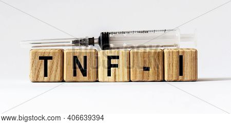 Text Tnf-i Made From Wooden Cubes. White Background
