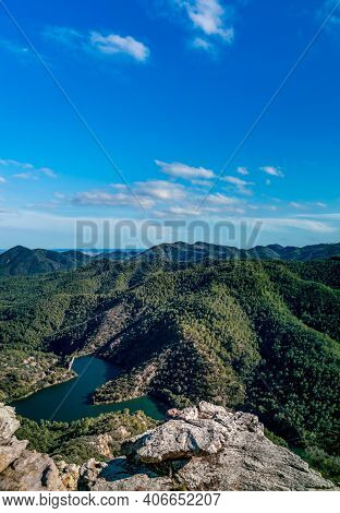 Rocks Viewpoint Over Mountain Range And Dam