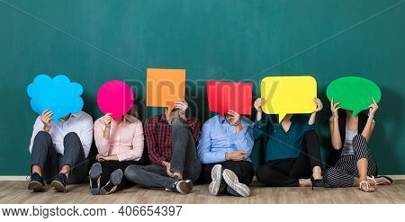 Group Of Six Business People Team Sittiing Together And Holding Colorful And Different Shapes Of Spe
