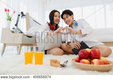 Lgbtq Couple Lovers, A Handsome Girl As Man Or Butch Join Their Finger To Be Heart Shape With Love A