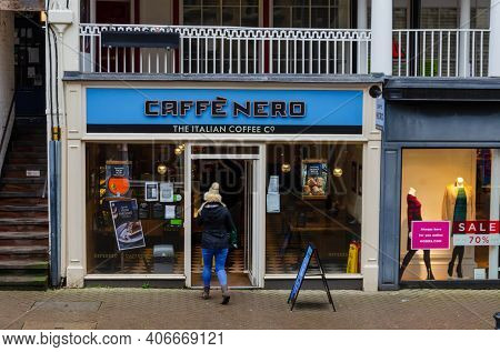 Chester; Uk: Jan 29, 2021: A Woman Enters The Caffe Nero Coffee Shop On Eastgate Street Which Is Ope