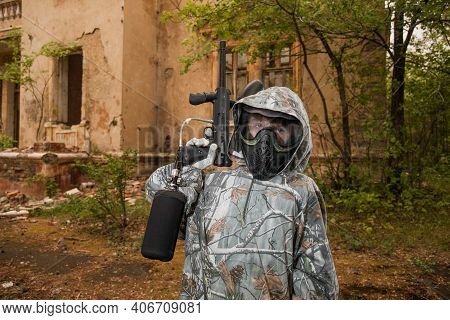 Boy Stands With A Gun In His Hand. Boy In A Gas Mask. \ra Young Man In A Protective Cloak And Hood. 