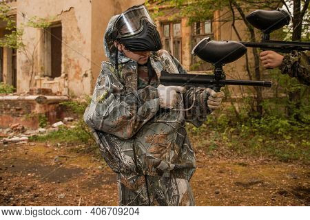 Boy Stands With A Gun In His Hand. Boy In A Gas Mask. \ra Young Man In A Protective Cloak And Hood. 