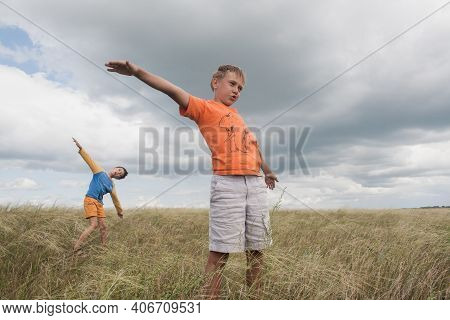 Boys Standing In A Field . Boys In Shorts.   Two Friends. Children Playing In The Field.