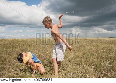 Boys Standing In A Field . Boys In Shorts.   Two Friends. Children Playing In The Field.