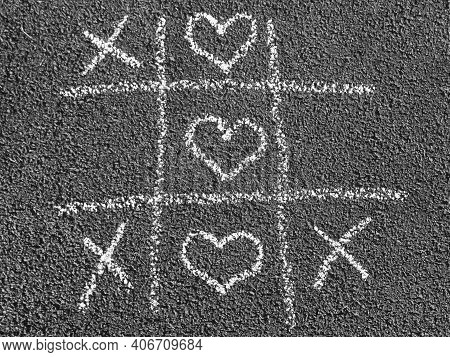 Chalk Tic-tac-toe Game With White Heart Drawings Instead Of Noughts