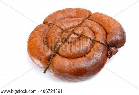 Smoked Sausage Twisted In A Spiral And Bound With A Beechnut, Isolated On A White Background.
