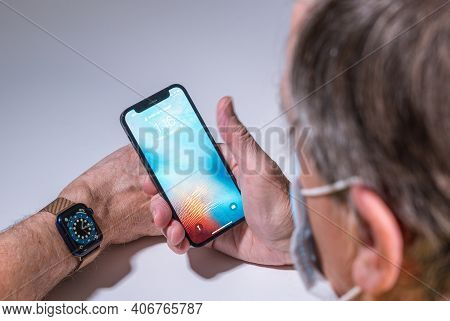 Morgantown, Wv - 5 February 2021: Apple Iphone And Watch Use Face Recognition To Open Phone Even Whe