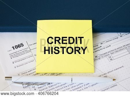 Tax Form 1065 With Yellow Sticker With Text Credit History. Notepad And White Pen