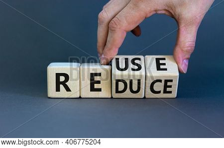 Reuse Or Reduce Symbol. Businessman Turns Wooden Cubes And Changes The Words Reduce To Reuse. Beauti