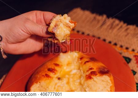 Woman Is Eating Adjarian Khachapuri With Hands, Crushing Egg Yolk.