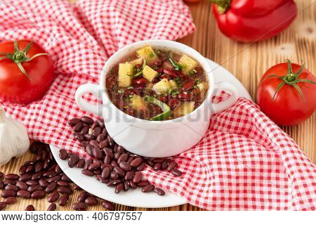 Bean Soup With Meat In A White Ceramic Bowl.