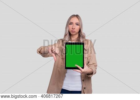 Girl Holding Tablet Green Screen Showing Thumb Down Isolated. Commecial, Shopping, Advertisment Conc