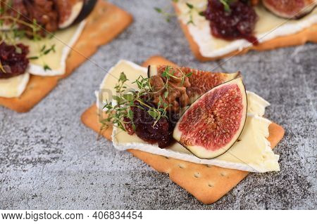 Cracker With A Slice Of Camembert, Jam, Figs And Nuts.
A Great Snack Idea For A Holiday, Picnic Or P