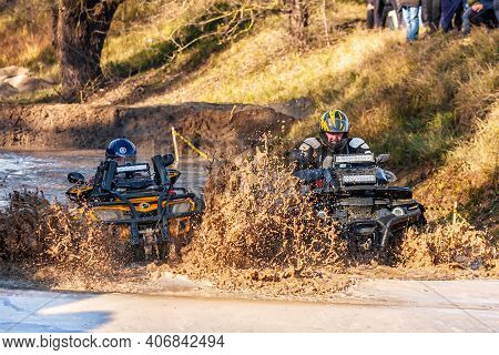 Afipsip, Russia - October 31, 2020: Sportsmen Drive Quad Bikes Splashing In Deep Water At Mud Racing