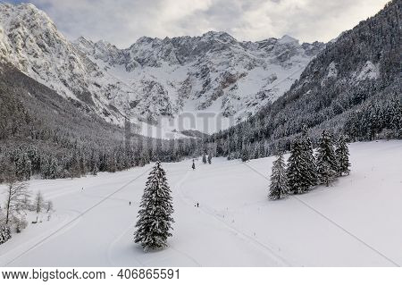 Aerial Winter Landscape Mountain Valley With Forest Covered In Snow. Zgornje Jezersko, Slovenia.