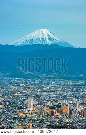 Kofu, Japan skyline with Mt. Fuji at dusk.