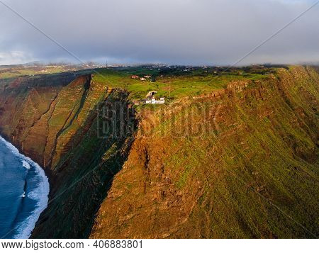 The Cliff Lighthouse Ponta Do Pargo On The Cliff Coast Of The Island Of Madeira - Wonderful Cloudy C