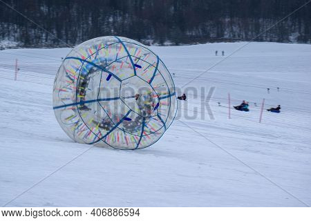 A Ball Of Zorbing Flying Down From A Snowy Mountain. Safari Park 
