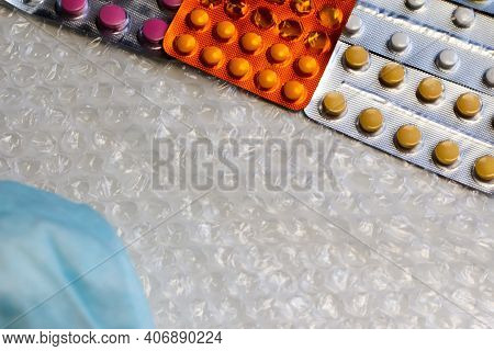 Blisters Of Packs Of Colored Pills Horizontally In The Corner. Frame For The Designer. Below Is A Bl