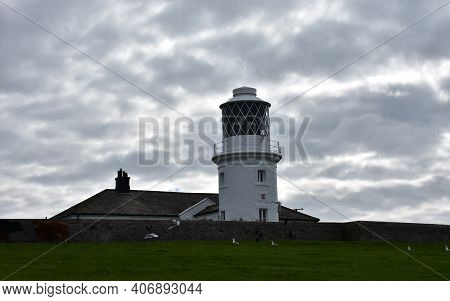 Lots Of Clouds Above St Bees Lighthouse In England.