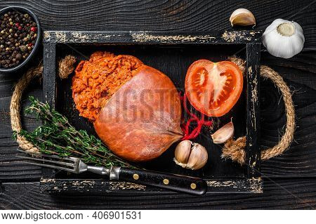 Mallorcan Sobrassada Cured Pork Meat Sausage In A Wooden Tray. Black Wooden Background. Top View