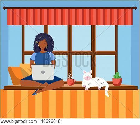 A Woman Works At A Laptop While Sitting On The Windowsill At Home. Freelance Concept, Quarantine Due