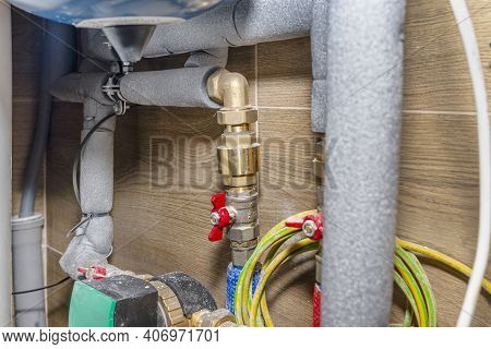 Natural Gas Valves And Pipes In A Modern Home Boiler Room With Ceramic Tiles, Visible Water Circulat