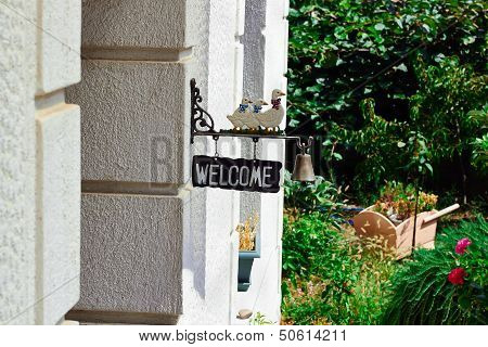 Welcome Sign With Bell And Ducks