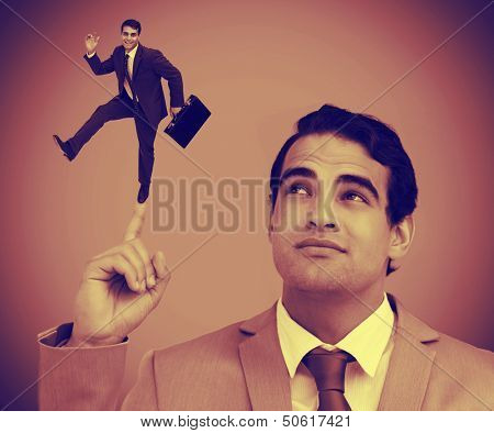 Businessman showing shrunk colleague with his briefcase on his finger