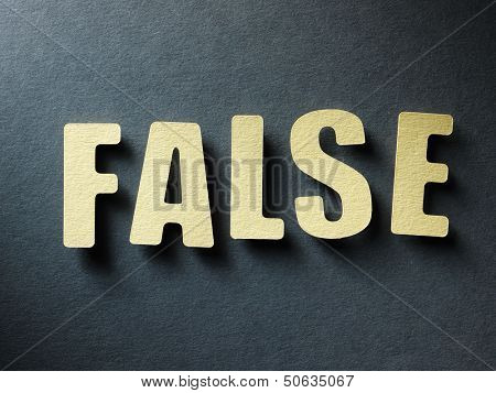 The word Flase in cut out paper letters on paper background