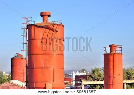 Industrial Landscape With Vermilion Towers