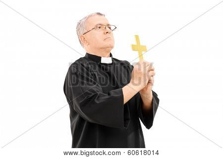 Mature reverend holding a holy cross and praying to god isolated on white background