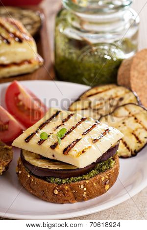 Vegetarian burger with cheese, eggplant and pesto