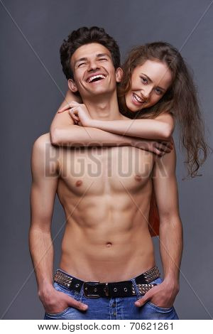 Shirtless young couple embracing