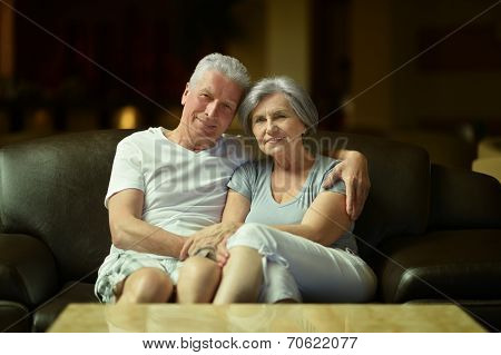 Old couple resting in hotel hall