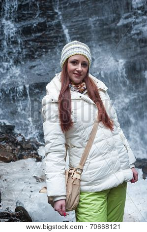 Woman Standing Near Mountain Waterfall